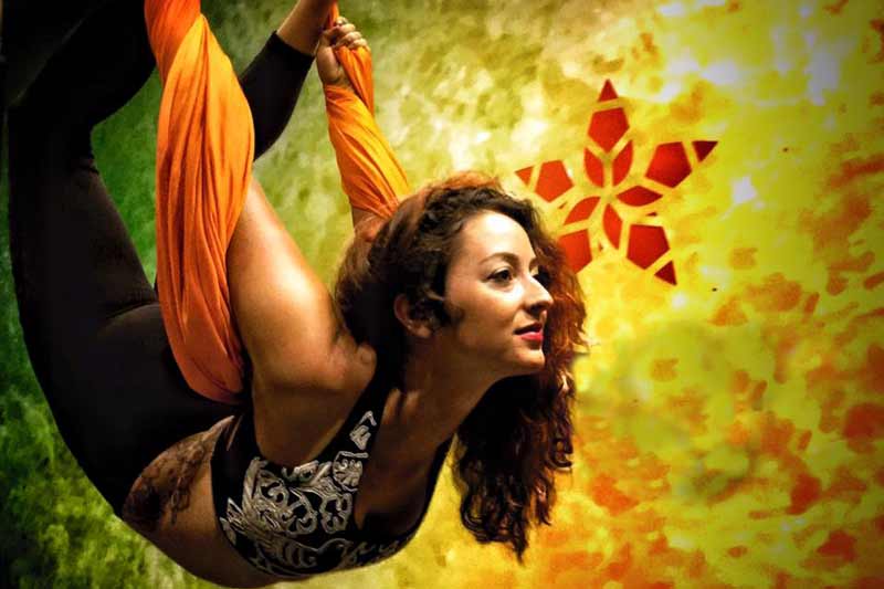 Jessie Rae doing aerial yoga in a yoga swing