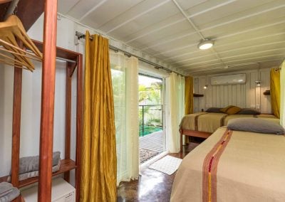 Inside our comfortable King Suite at Danyasa Eco Retreat where you can enjoy A/C, WiFi, premium bedding, a private bath and patio