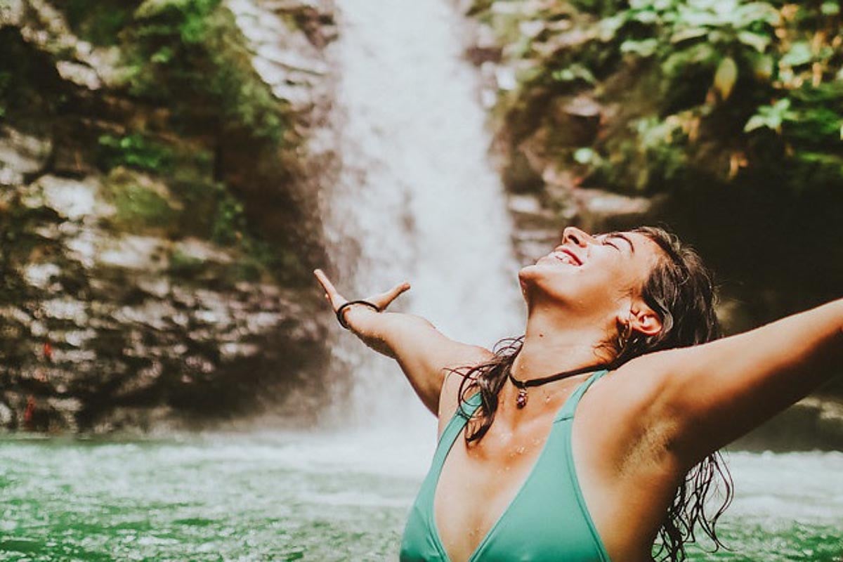 Woman in waterfall at Danyasa Yoga Retreat