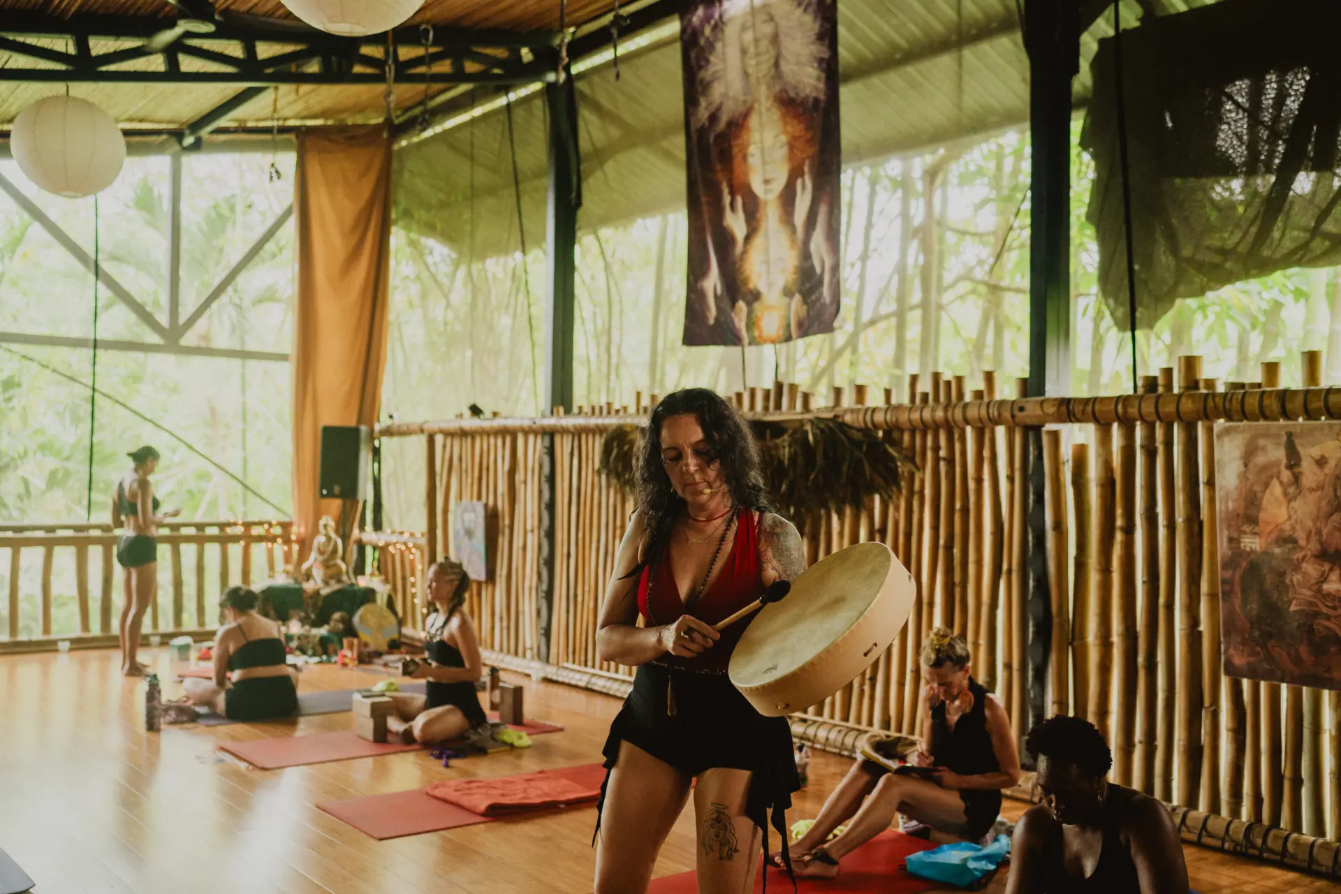 teacher-drumming-students-journaling-open-air-yoga-studio.jpg
